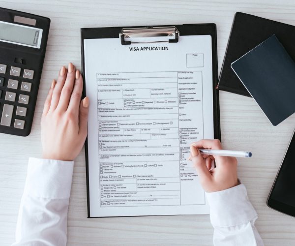 top-view-of-woman-holding-pen-near-document-with-visa-application-lettering-near-smartphone-with-e1692632864660.jpg top-view-of-woman-holding-pen-near-document-with-visa-application-lettering-near-smartphone-with-e1692632864660.jpg